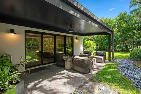 a view of a patio with couches chairs and a yard