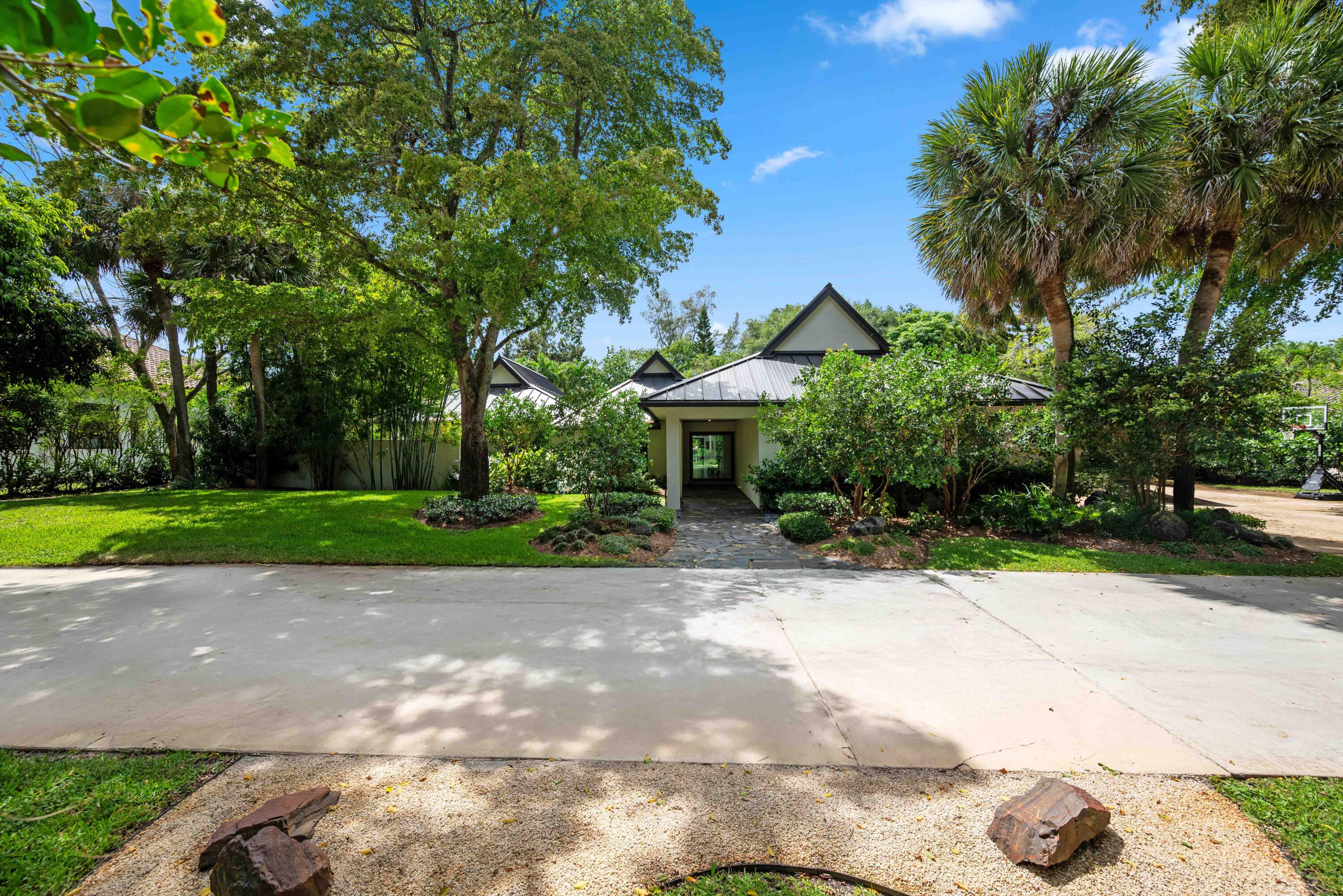 18660 Long Lake Drive Boca Raton, FL 33496 - Photo 6 of 75 a view of a patio with a table and chairs under an umbrella
