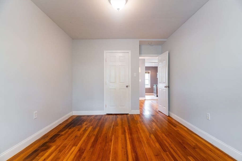 65 Rossmore Road, Unit 1R Boston, MA 02130 - Photo 13 of 21 a view of a room with wooden floor and brick walls