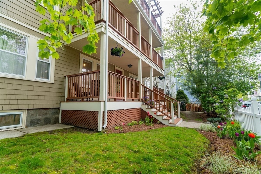 65 Rossmore Road, Unit 1R Boston, MA 02130 - Photo 16 of 21 a view of backyard with a garden and deck