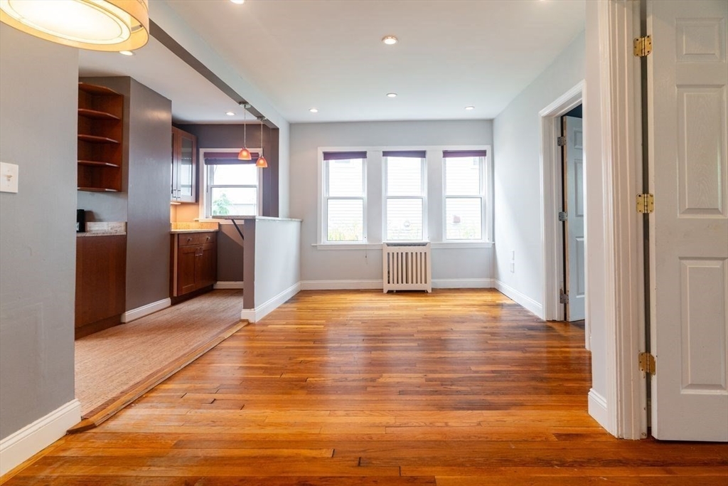 65 Rossmore Road, Unit 1R Boston, MA 02130 - Photo 6 of 21 a view of an empty room with window and wooden floor