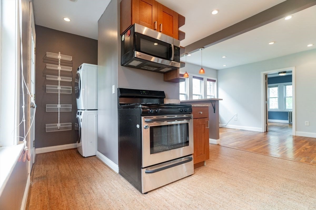 65 Rossmore Road, Unit 1R Boston, MA 02130 - Photo 8 of 21 a kitchen with stainless steel appliances granite countertop a stove and a refrigerator