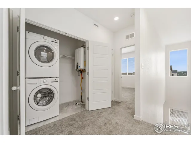 a view of a storage and utility room with washer and dryer