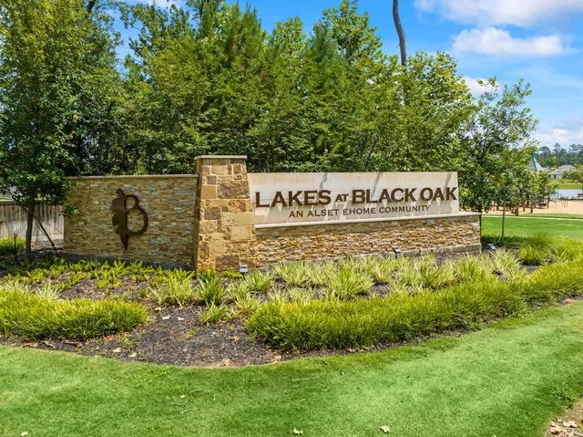 a view of a swimming pool with a bench and lawn chairs