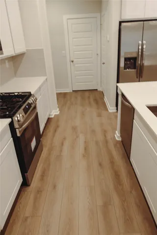 a kitchen with a sink and a stove top oven
