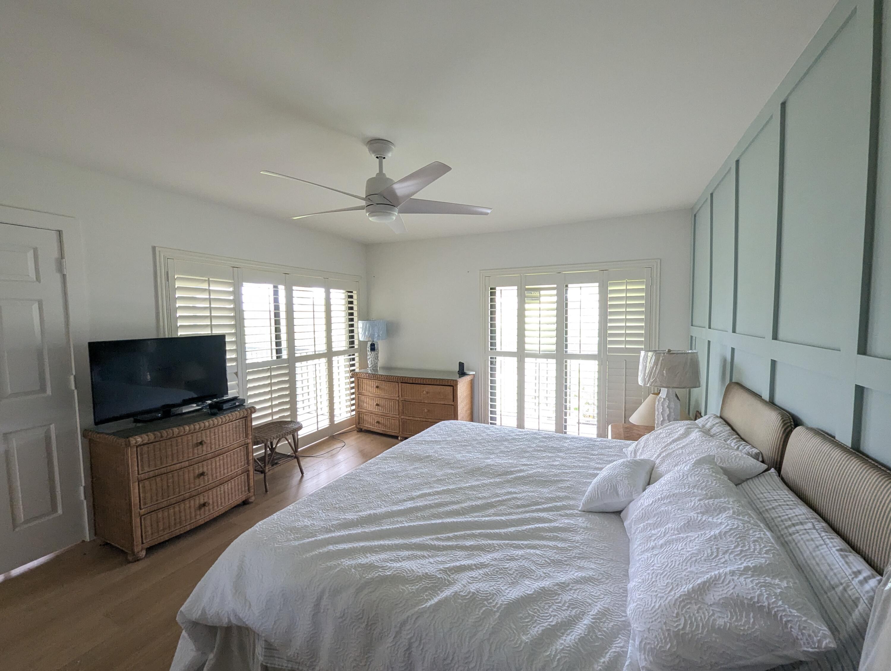 404 Clubhouse Circle Jupiter, FL 33477 - Photo 14 of 20 a bedroom with a bed flat screen tv and a window