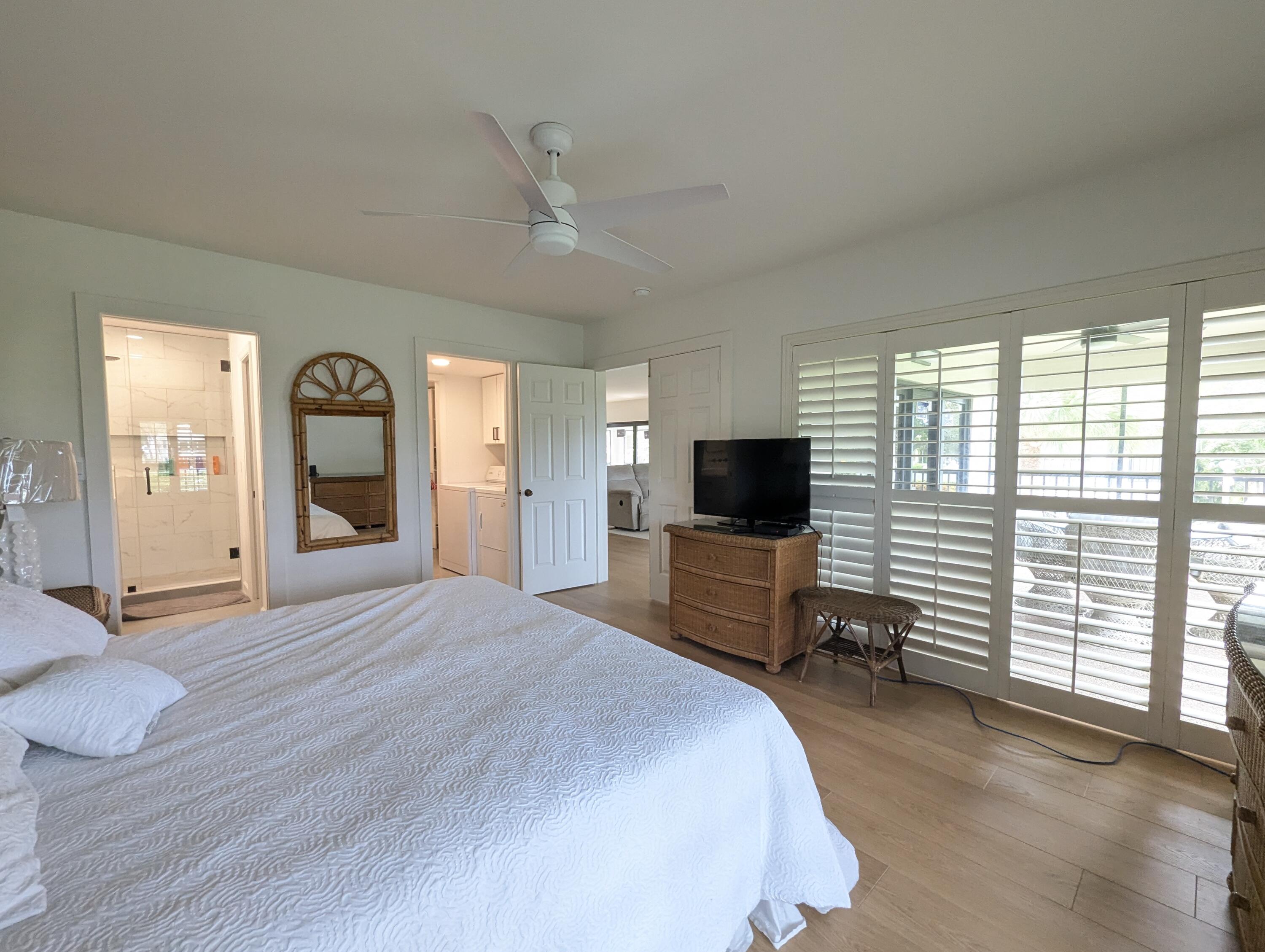 404 Clubhouse Circle Jupiter, FL 33477 - Photo 15 of 20 a bedroom with a bed and a television in it