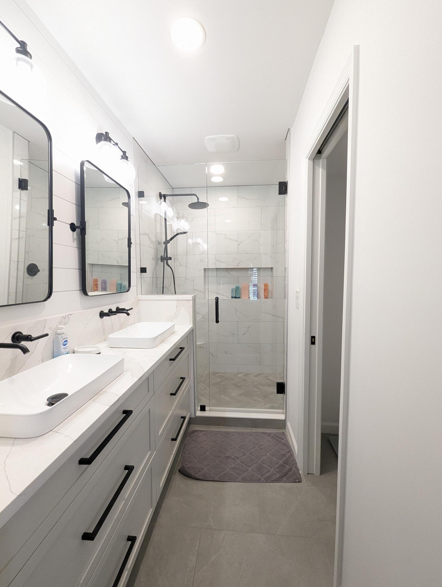 404 Clubhouse Circle Jupiter, FL 33477 - Photo 16 of 20 a spacious bathroom with a double vanity sink mirror and shower