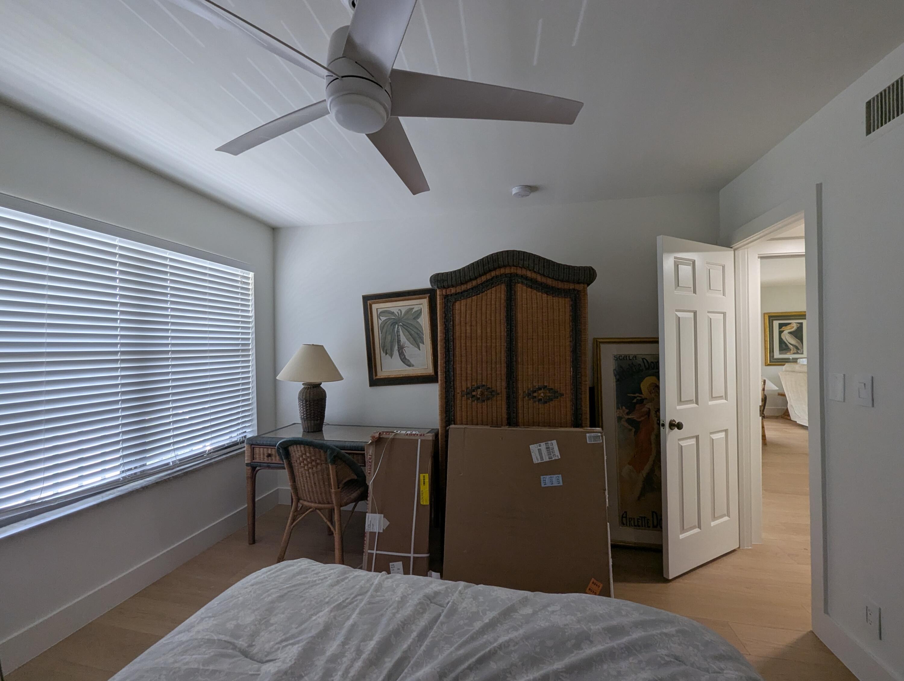 404 Clubhouse Circle Jupiter, FL 33477 - Photo 18 of 20 a bedroom with a bed and a window