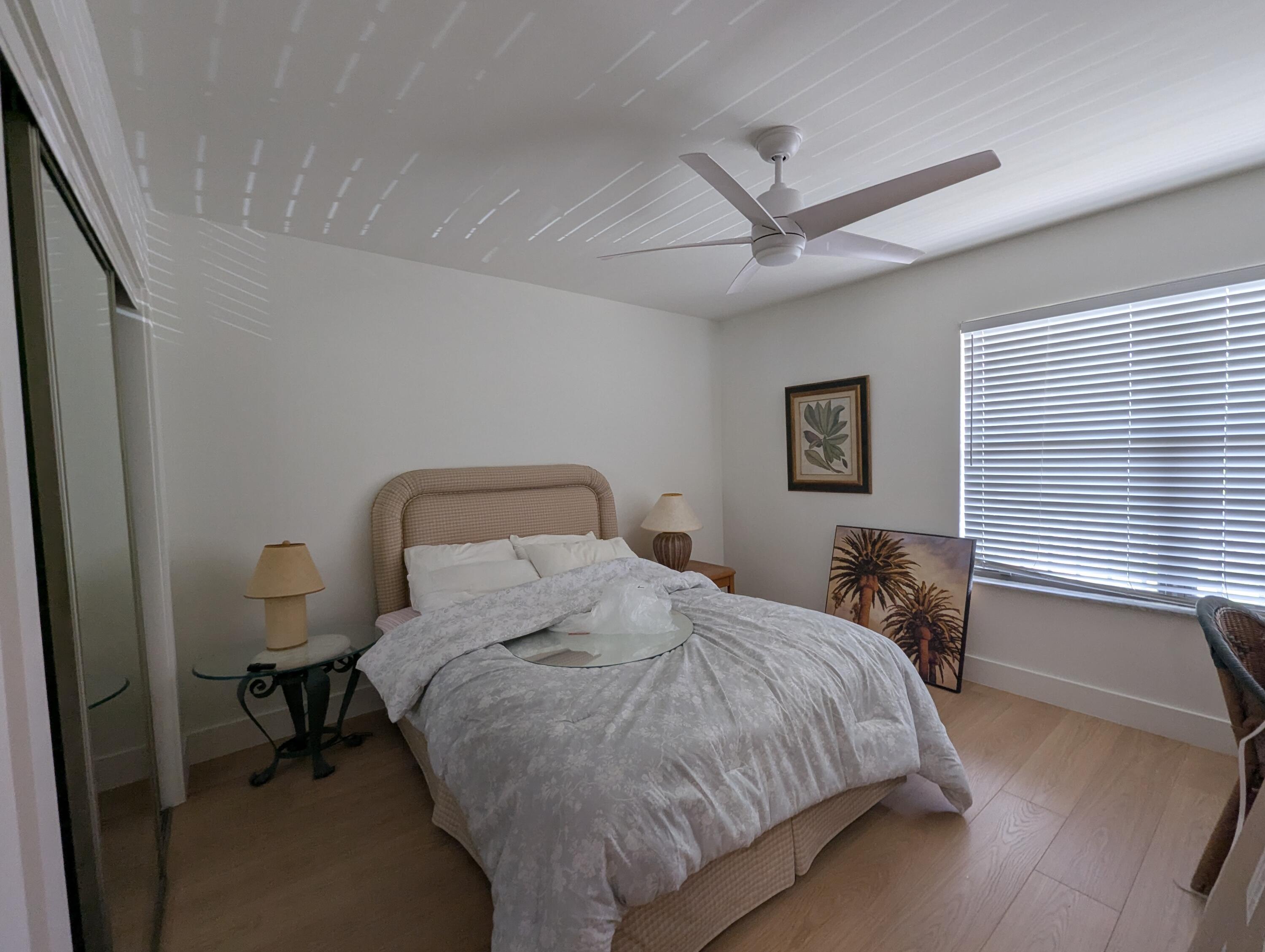 404 Clubhouse Circle Jupiter, FL 33477 - Photo 19 of 20 a bedroom with a bed and a window