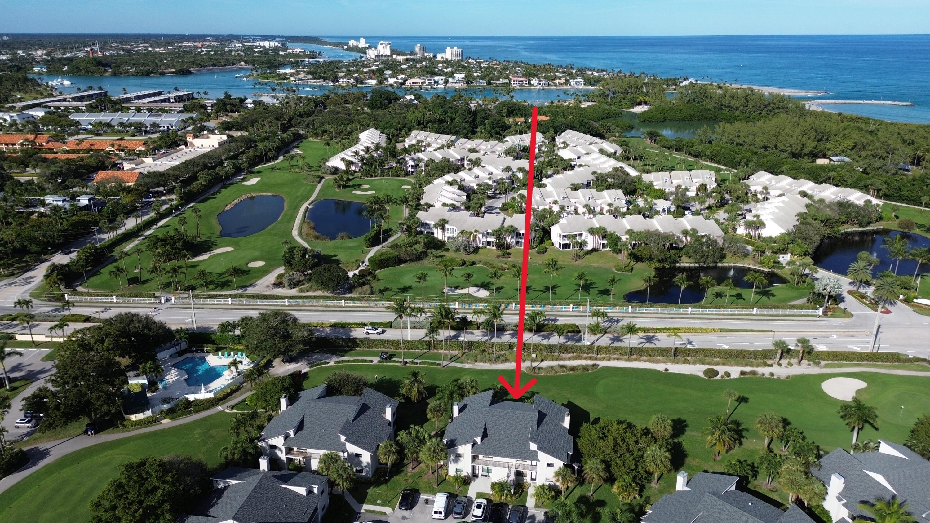 404 Clubhouse Circle Jupiter, FL 33477 - Photo 2 of 20 an aerial view of a city with lots of residential buildings ocean and mountain view in back