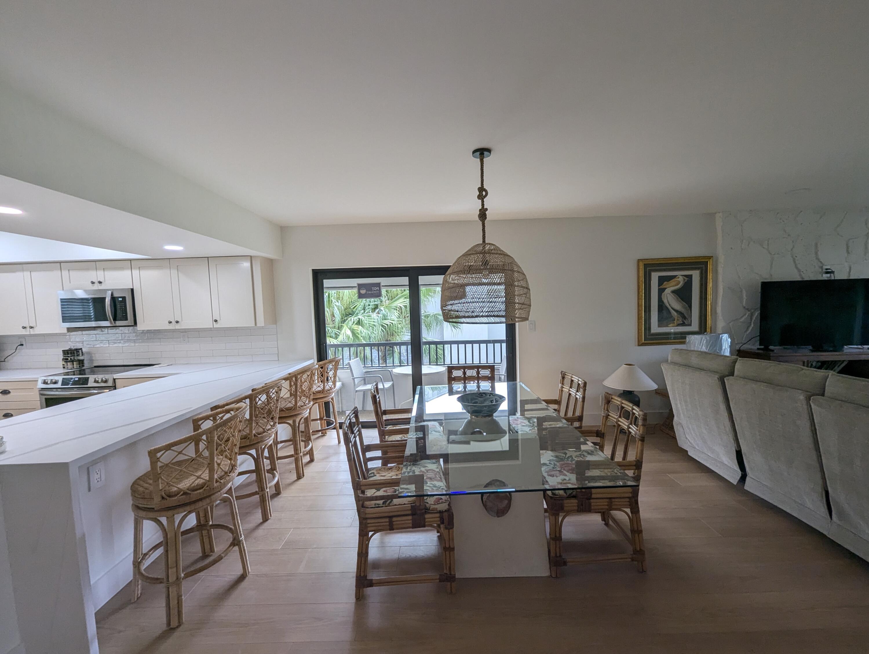 404 Clubhouse Circle Jupiter, FL 33477 - Photo 4 of 20 a view of a dining room with furniture