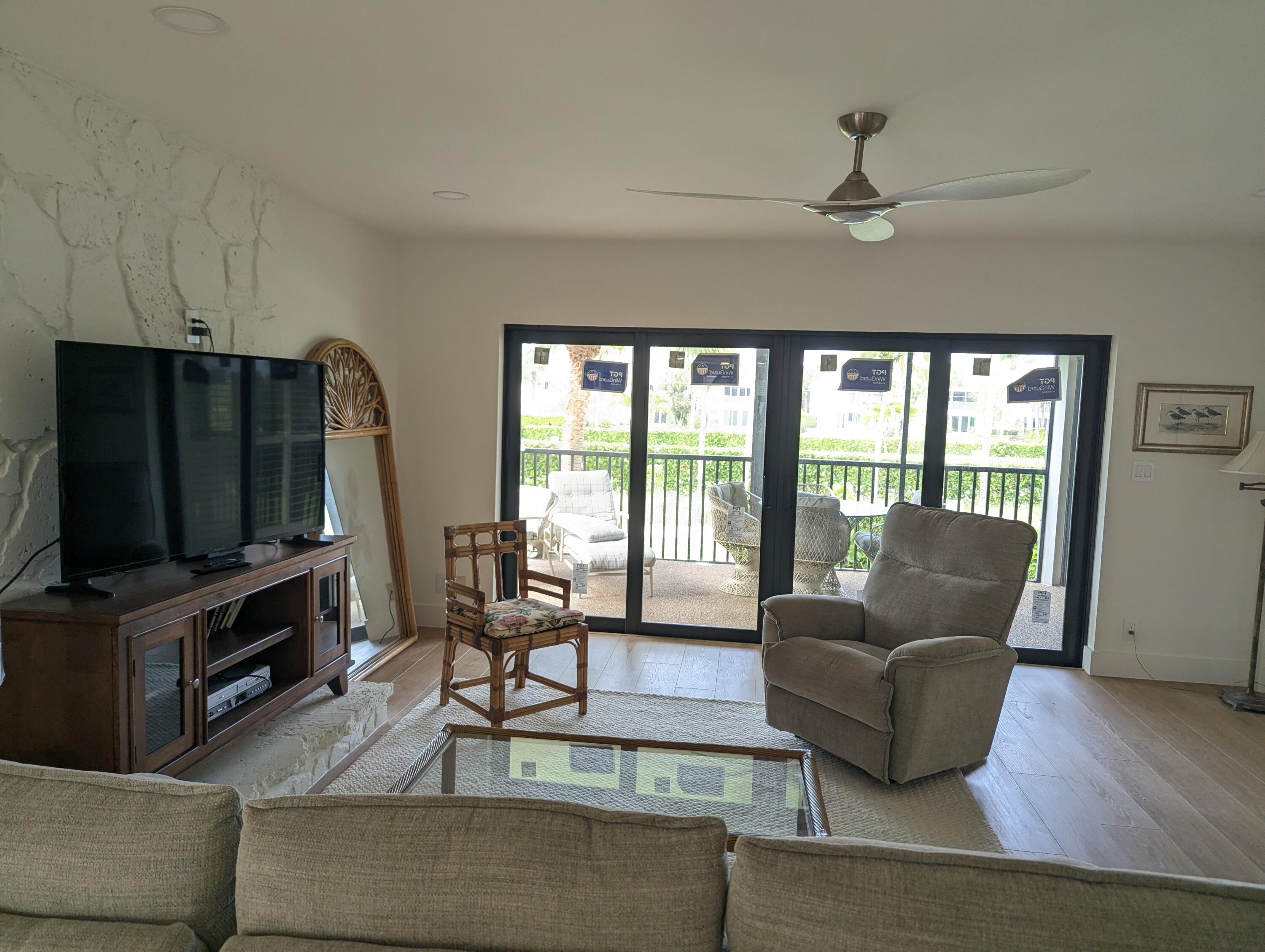 404 Clubhouse Circle Jupiter, FL 33477 - Photo 9 of 20 a living room with furniture and a flat screen tv