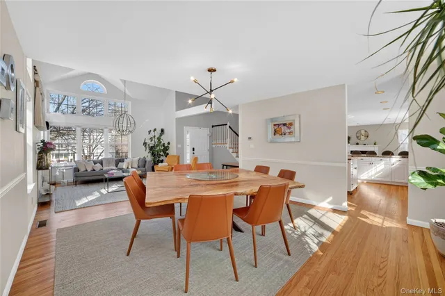 a view of a dining room with furniture and chandelier