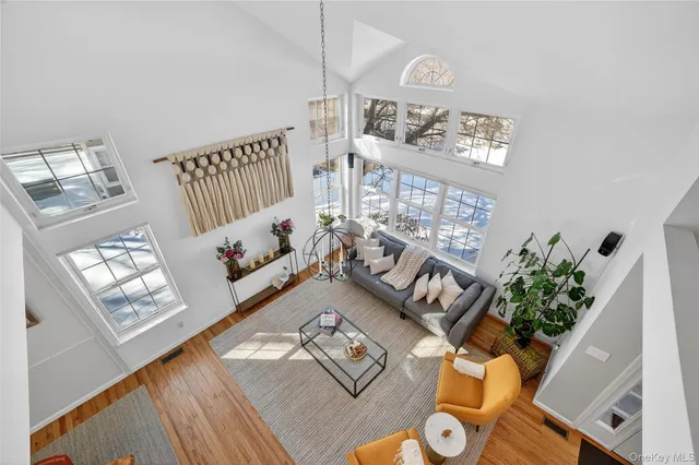 a living room with furniture a fireplace and a floor to ceiling window
