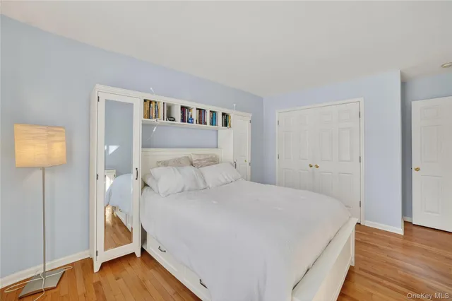 a bathroom with a granite countertop sink a mirror and a bathtub