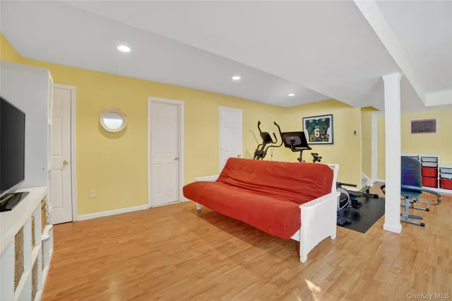 a view of a workspace with furniture and wooden floor