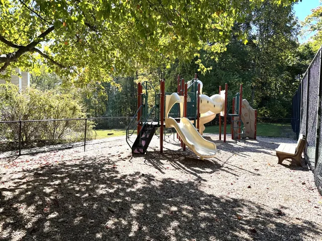 an aerial view of a house with garden space and street view