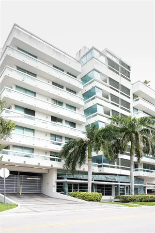 a front view of a building with glass windows and a table