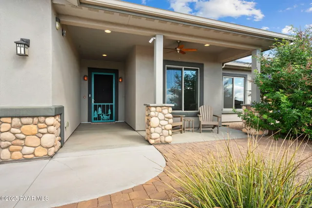 a living room with furniture kitchen view and a fireplace