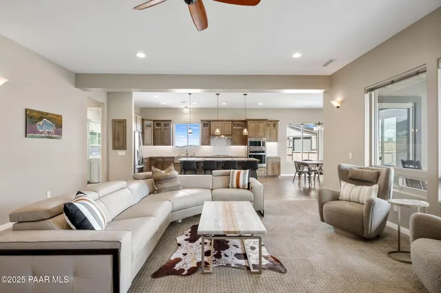 a dining room with wooden floor a chandelier a wooden table and chairs
