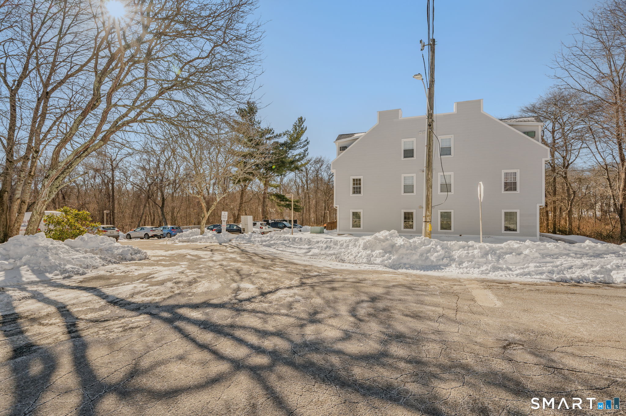 82 Sunset Street, Unit 73 Waterford, CT 06385 - Photo 5 of 19 a view of a white house with a yard covered in snow