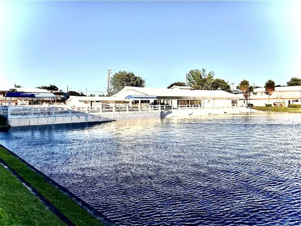 a view of swimming pool with outdoor seating and yard in back