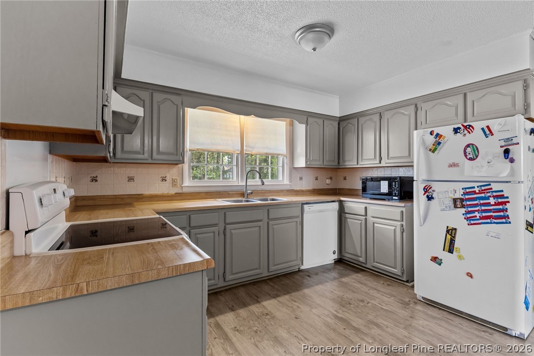 908 Ruton Court Fayetteville, NC 28303 - Photo 13 of 29 a kitchen with granite countertop a sink a window stainless steel appliances and cabinets