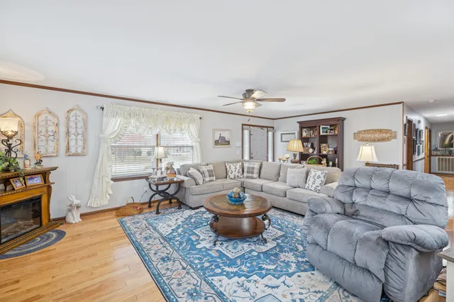 a living room with furniture and a view of kitchen