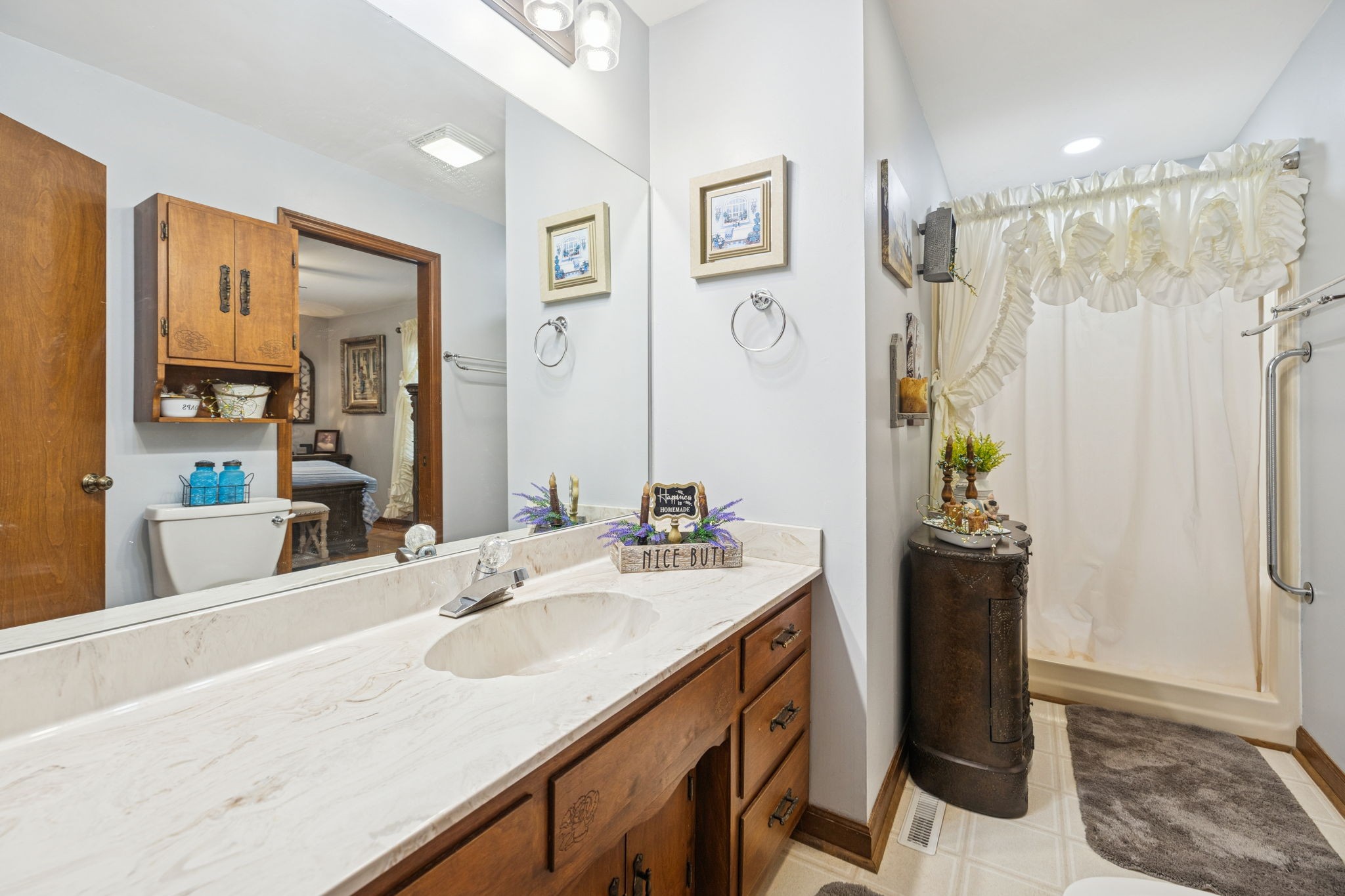 272 Belmar Circle Manchester, TN 37355 - Photo 16 of 56 a bathroom with a double vanity sink and a mirror