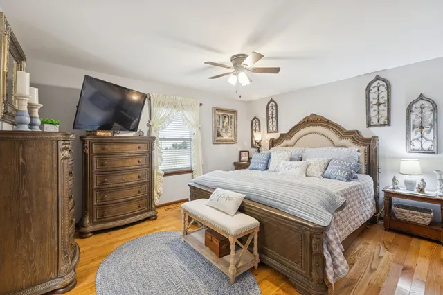 a bedroom with a large bed a chandelier and closet