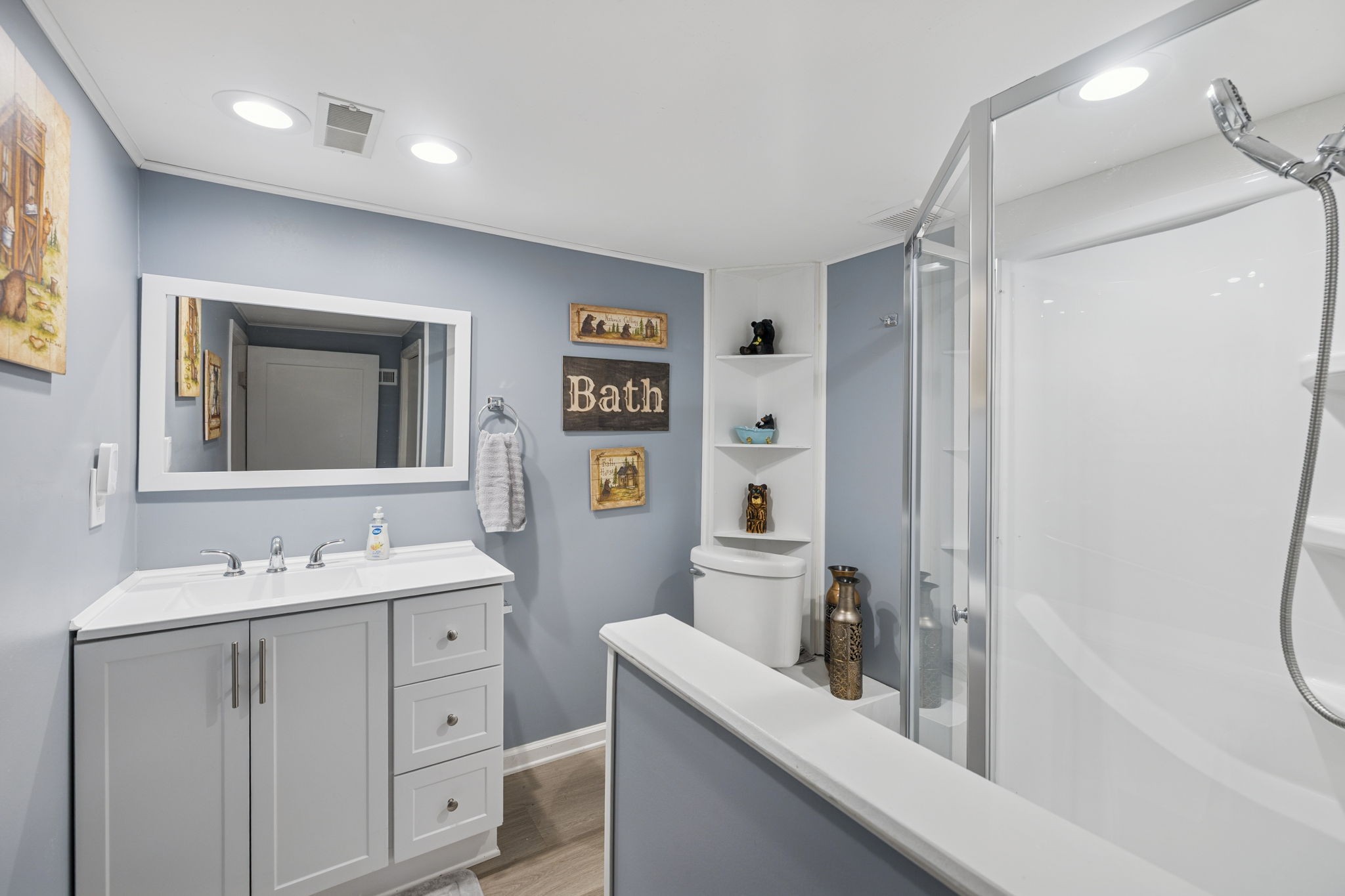 272 Belmar Circle Manchester, TN 37355 - Photo 31 of 56 a bathroom with a double vanity sink a mirror and a shower