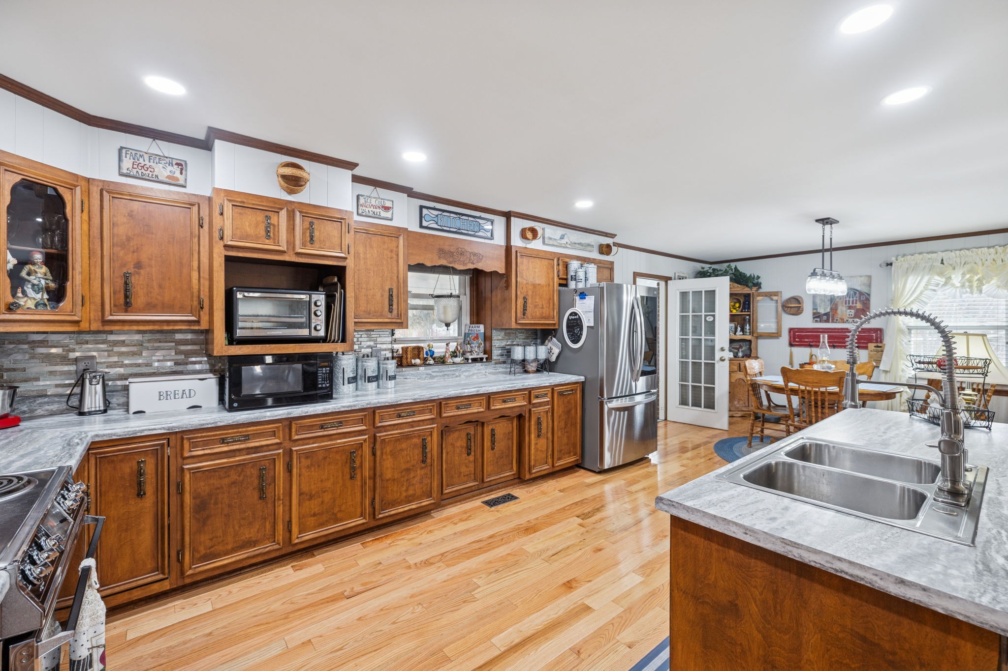 272 Belmar Circle Manchester, TN 37355 - Photo 6 of 56 a kitchen with stainless steel appliances granite countertop a sink stove and wooden cabinets