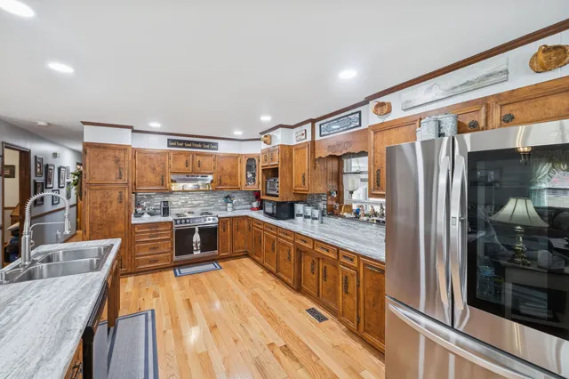 a kitchen with a refrigerator sink and cabinets