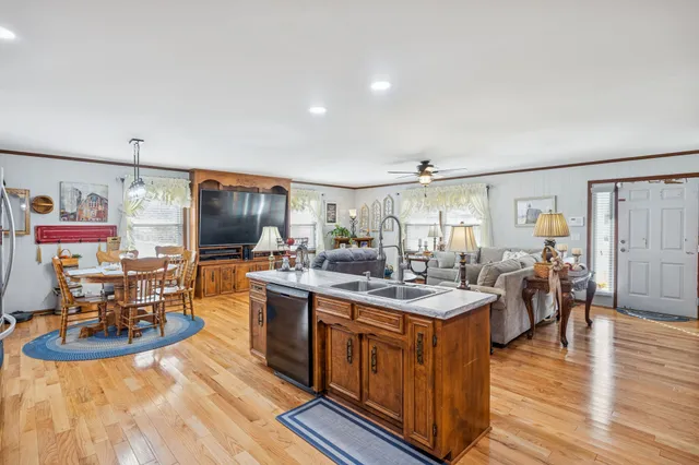 a view of a dining room with furniture a chandelier and wooden floor