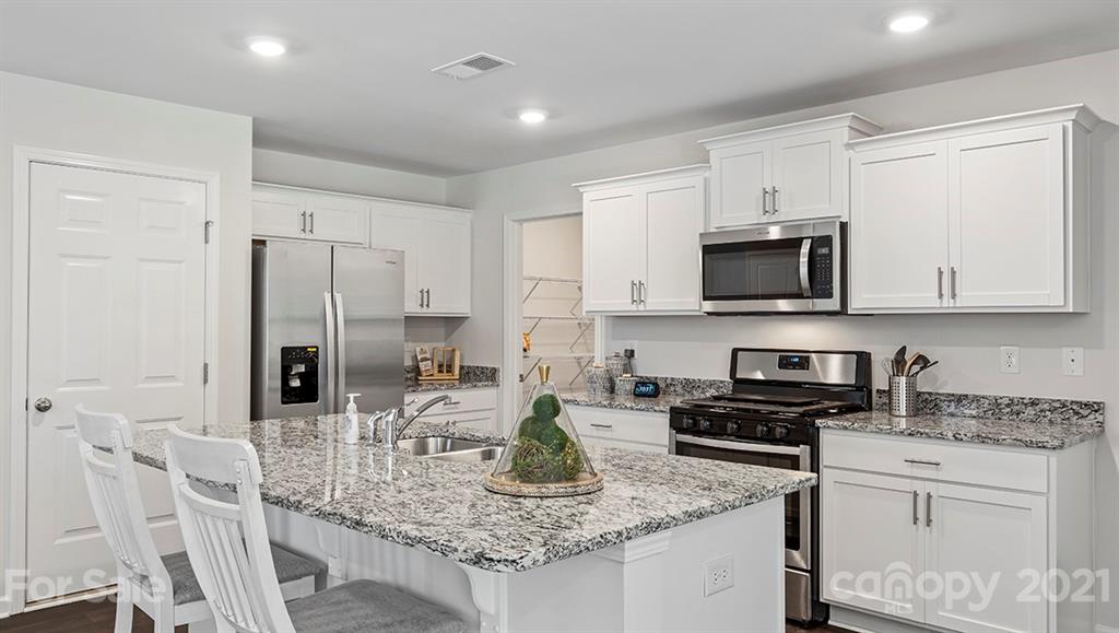 342 Gaines Road Clover, SC 29710 - Photo 7 of 32 a kitchen with stainless steel appliances granite countertop a sink refrigerator and cabinets