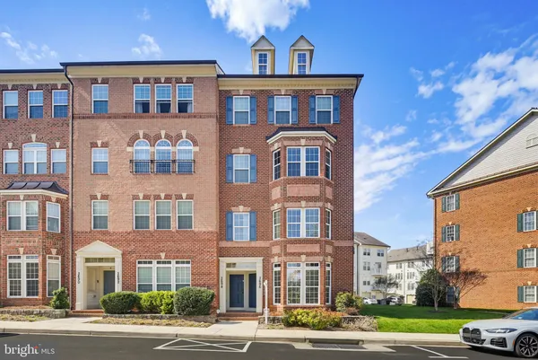 a front view of a residential apartment building with a yard