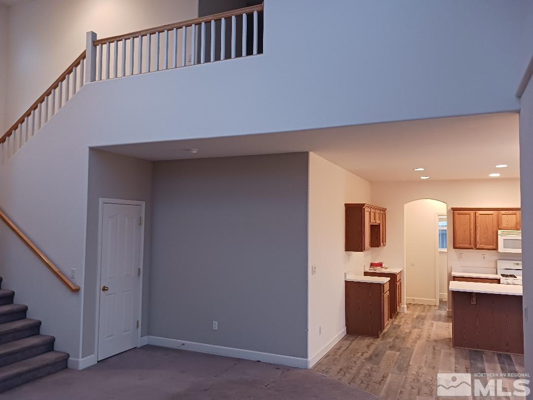 2217 Table Rock Drive Carson City, NV 89706 - Photo 4 of 28 a hallway with stainless steel appliances kitchen island sink refrigerator and stove