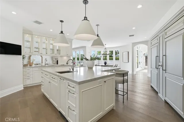 a dining room with furniture a chandelier and wooden floor