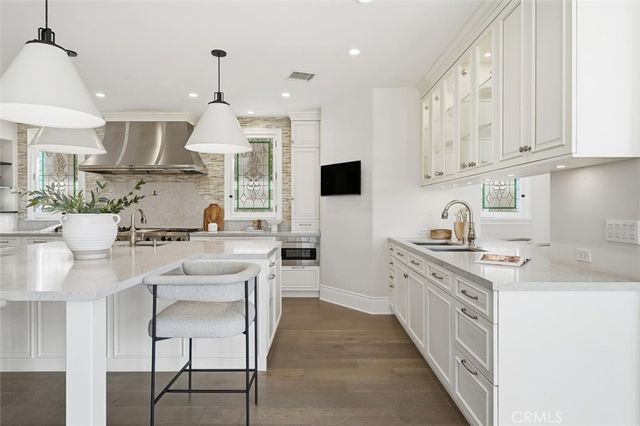 a kitchen with white cabinets and appliances