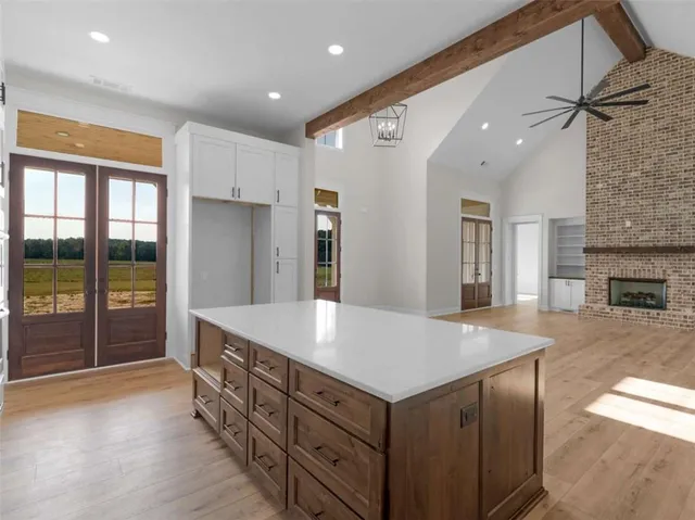 a large kitchen with kitchen island a sink stainless steel appliances and cabinets