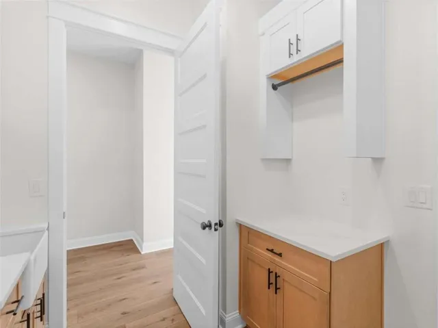 an empty room with a window and ceiling fan