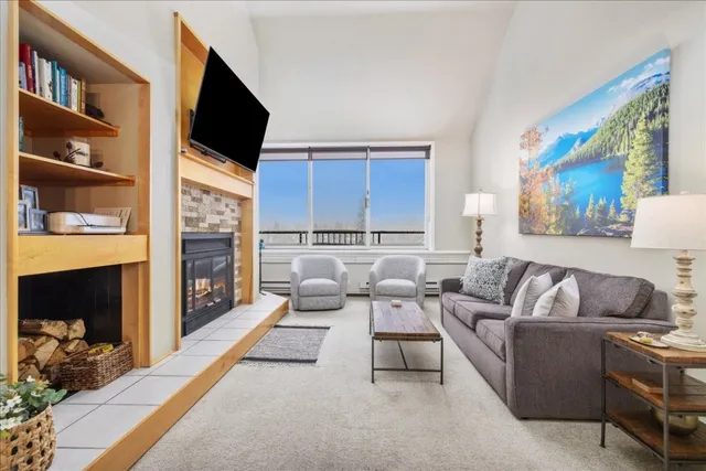 a living room with furniture a flat screen tv and a fireplace