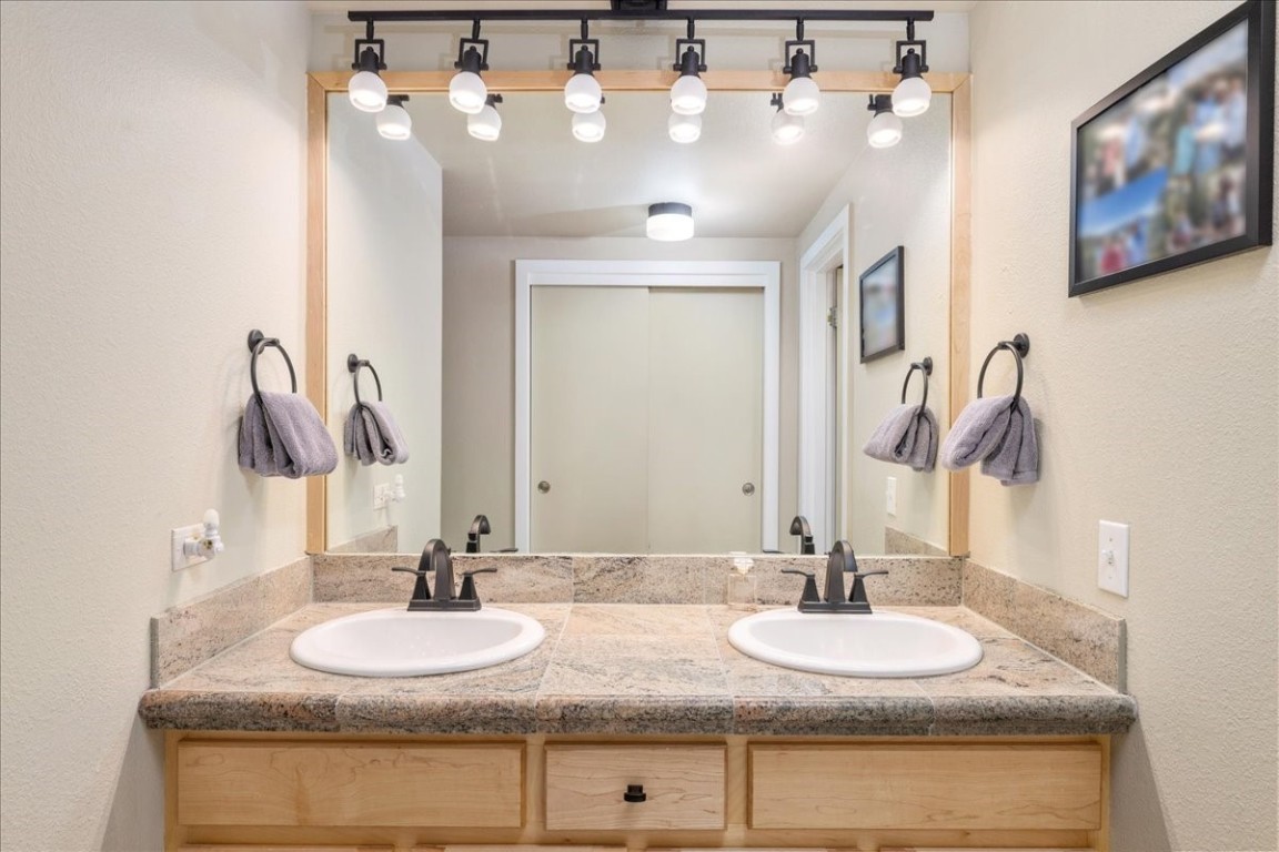 21650 Highway 6, Unit 2106 Keystone, CO 80435 - Photo 11 of 44 a bathroom with a double vanity sink and a mirror