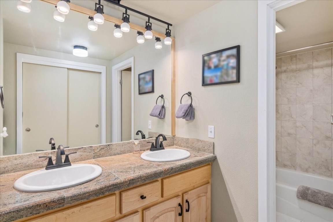 21650 Highway 6, Unit 2106 Keystone, CO 80435 - Photo 12 of 44 a bathroom with a granite countertop sink a mirror and vanity
