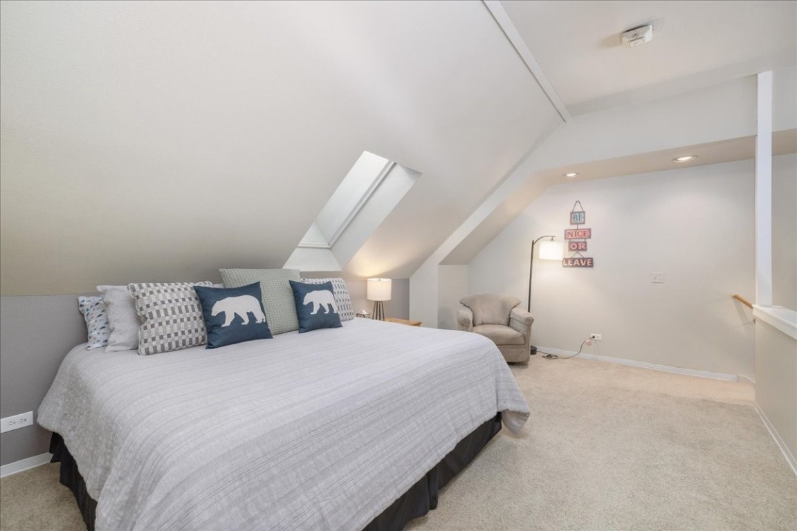 21650 Highway 6, Unit 2106 Keystone, CO 80435 - Photo 16 of 44 a bedroom with a bed and a night stand