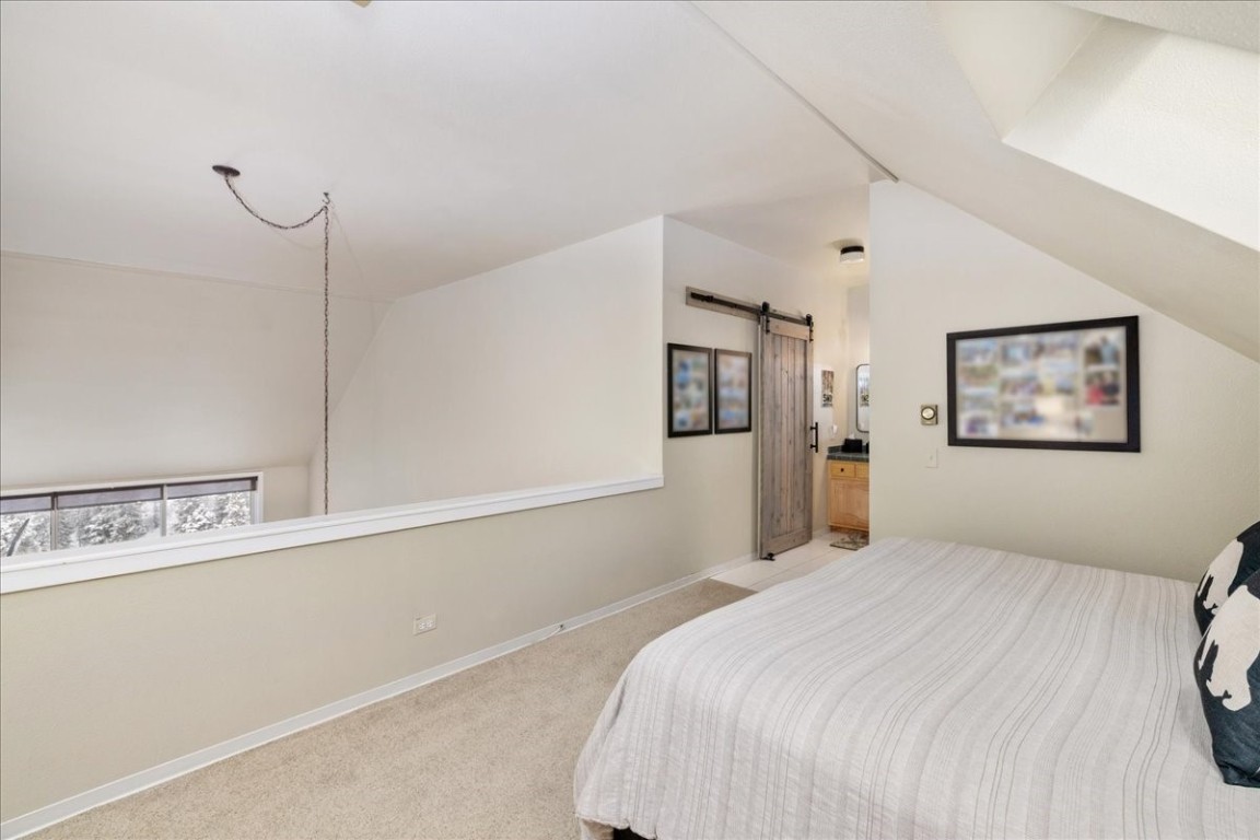 21650 Highway 6, Unit 2106 Keystone, CO 80435 - Photo 24 of 44 a bedroom with a bed and a window