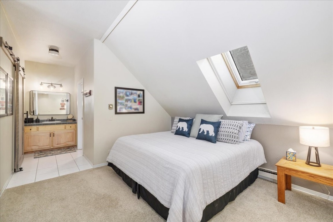 21650 Highway 6, Unit 2106 Keystone, CO 80435 - Photo 25 of 44 a bedroom with a bed and a view of bathroom