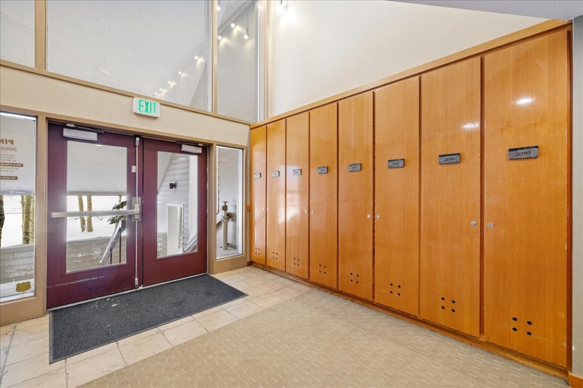 21650 Highway 6, Unit 2106 Keystone, CO 80435 - Photo 34 of 44 a view of a hallway with wooden shelves