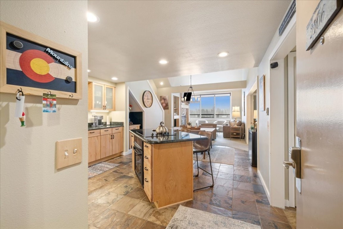 21650 Highway 6, Unit 2106 Keystone, CO 80435 - Photo 36 of 44 a kitchen with refrigerator and chairs